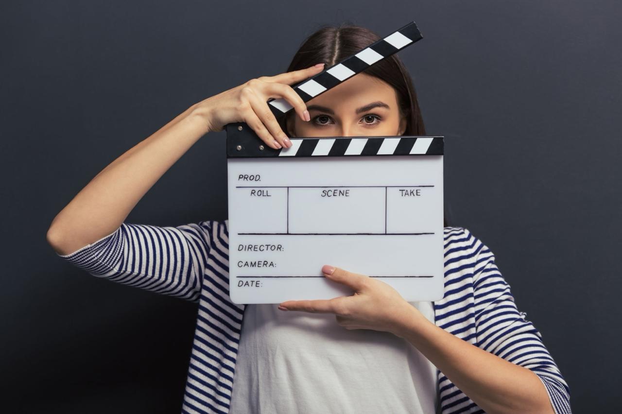 Participant holding a clapperboard, ready to shoot